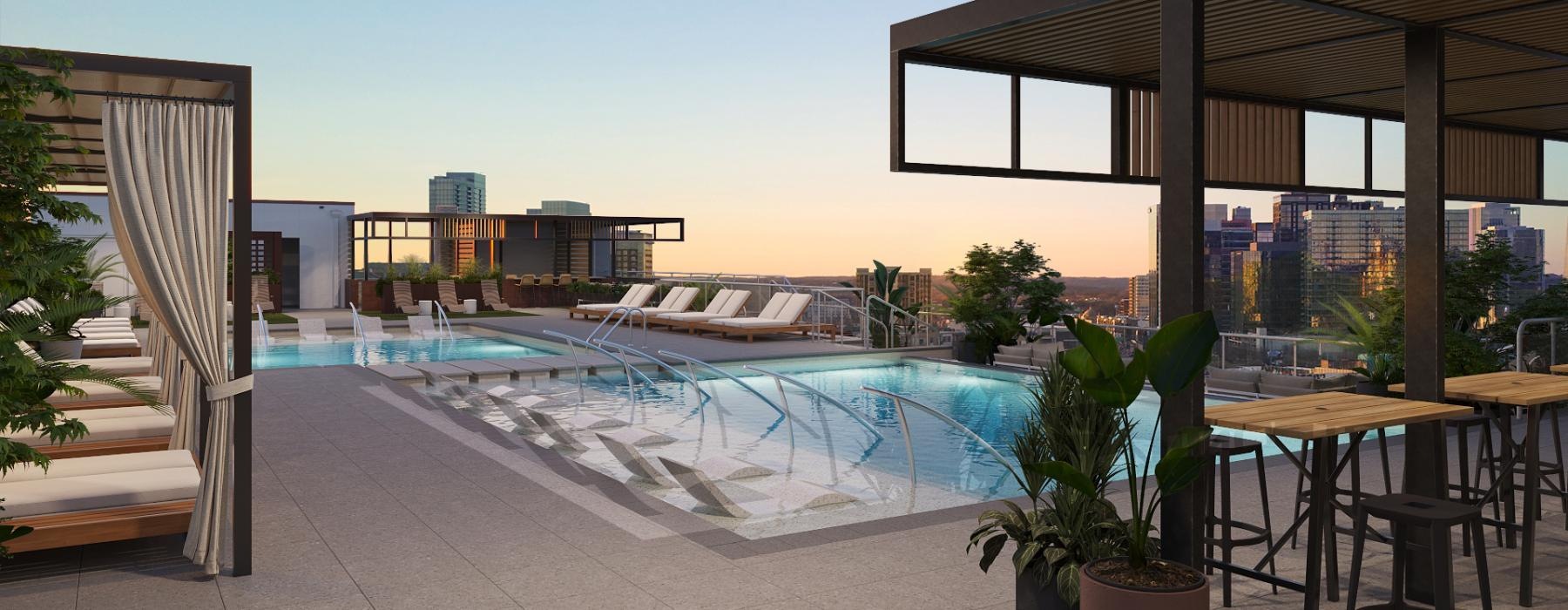 a swimming pool with a deck and chairs and a building in the background