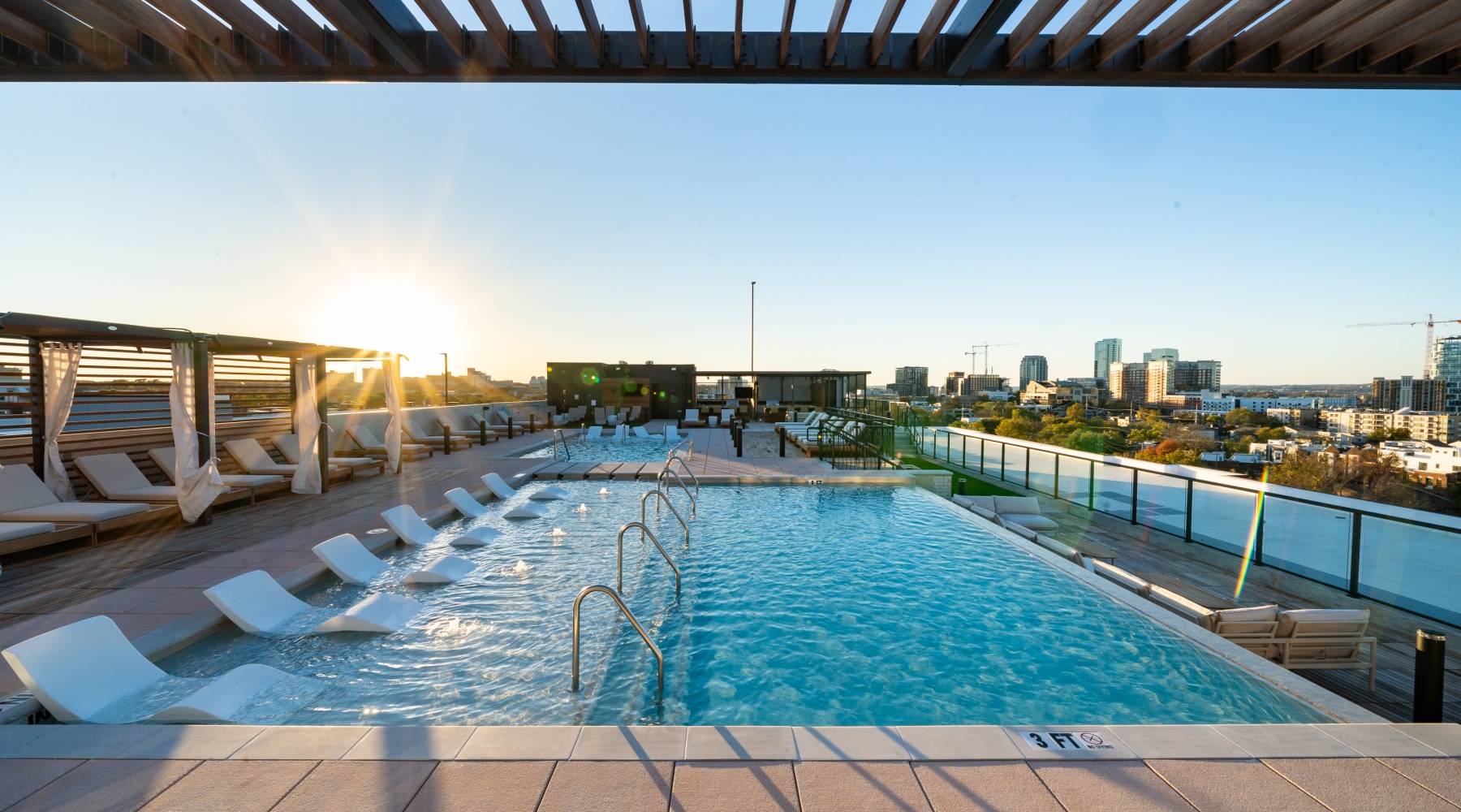 Rooftop pool with lounge chairs at Alta Rochelle Nashville aparmtents.
