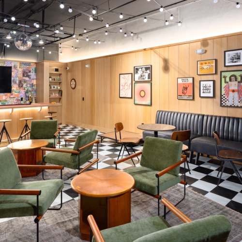 A room with a bar and lounge seating.