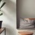 a plant in a pot next to a table and chairs